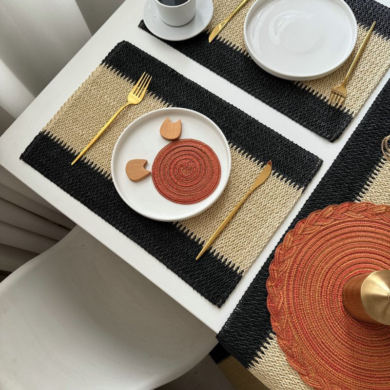 Sailorine light placemats over a dark table runner with white plates