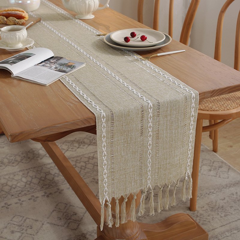 Sailorine neutral woven table runner with tassels on a set dining table