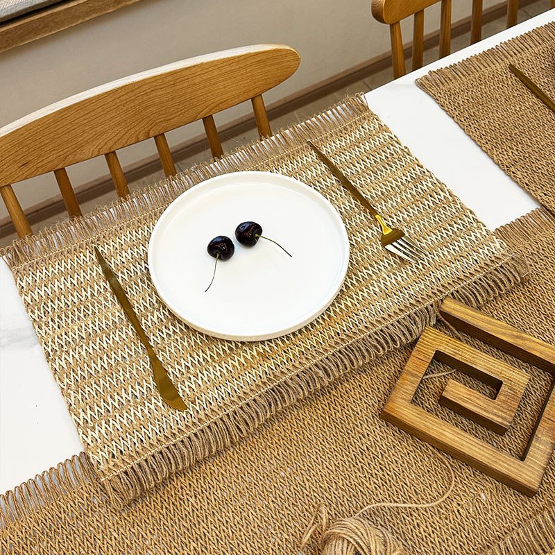 Sailorine light woven placemat beneath a white plate at a dining table