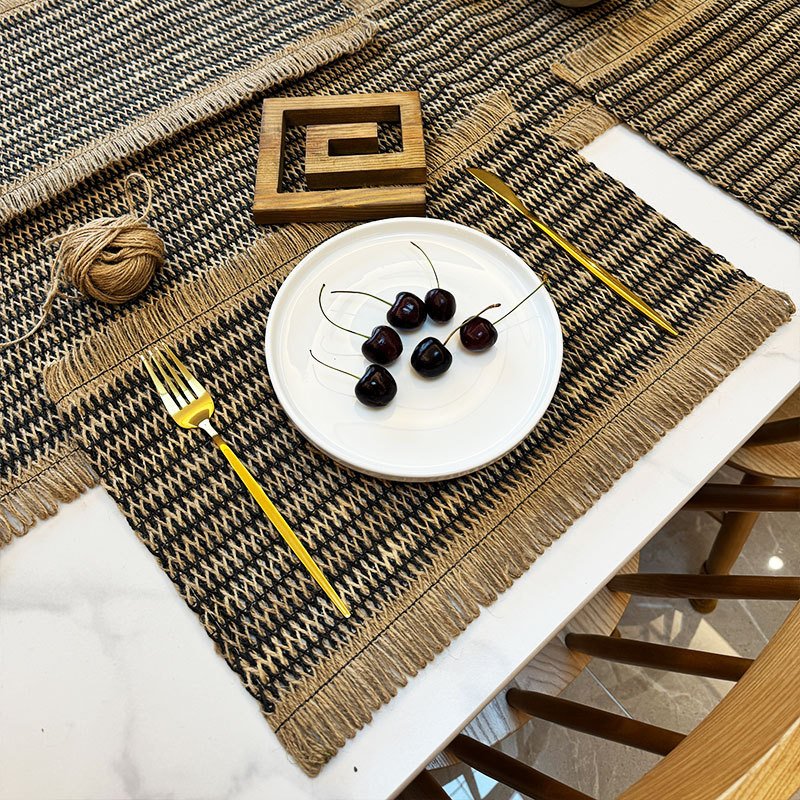Sailorine dark striped placemat with a white plate and cherries