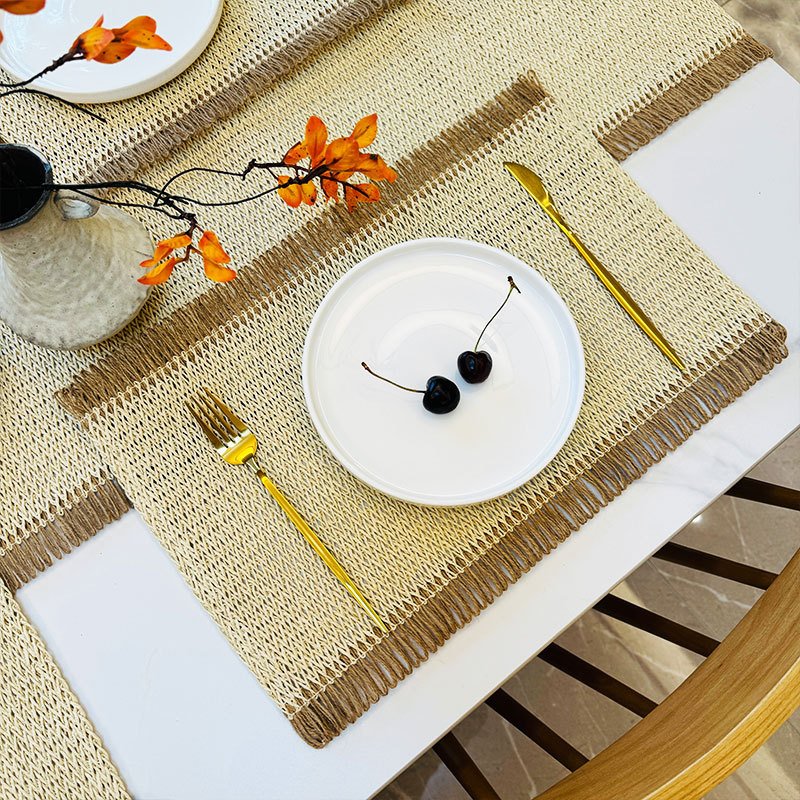 Sailorine light woven placemat with a white plate and yellow-handled cutlery