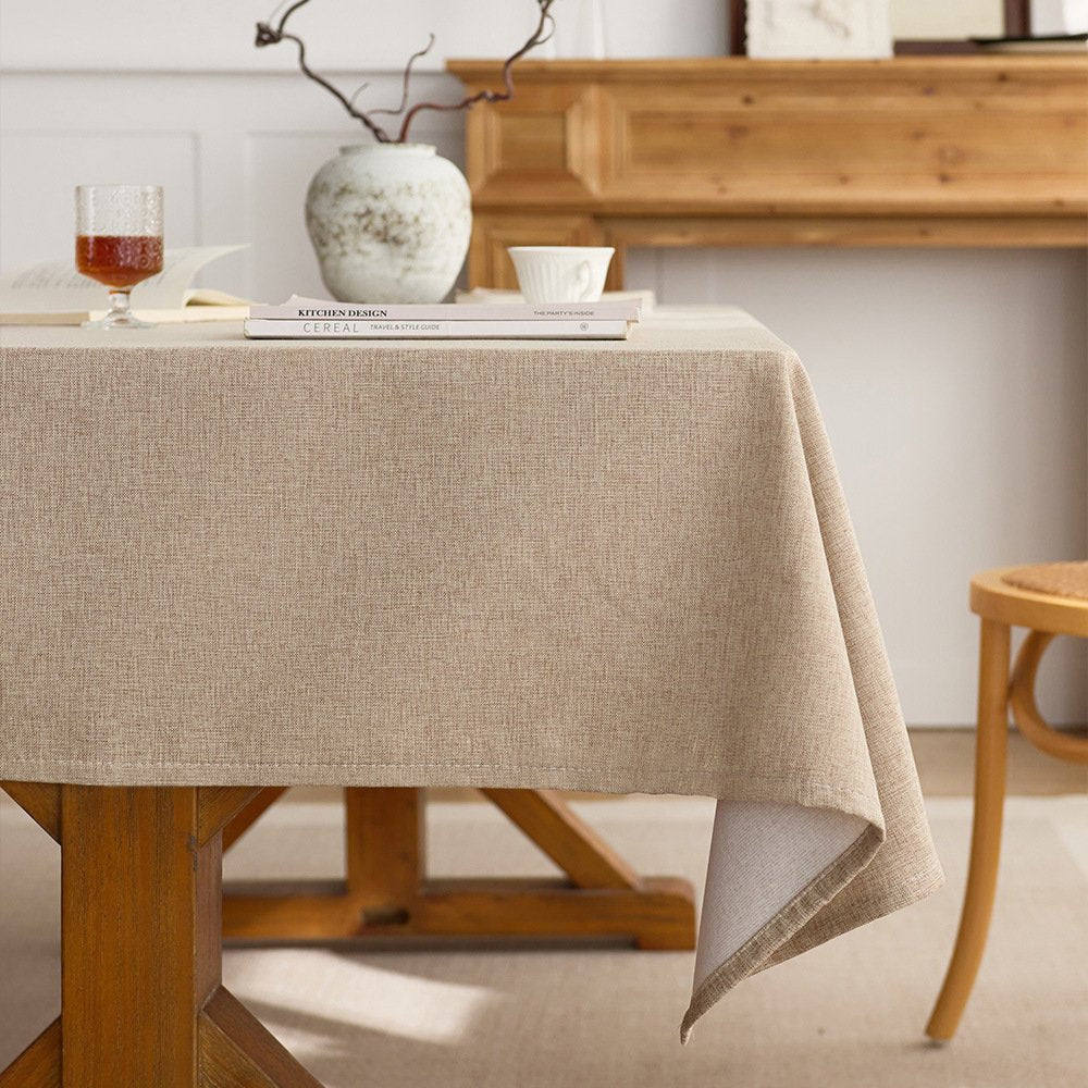 Sailorine beige tablecloth draped over a kitchen table beneath a vase