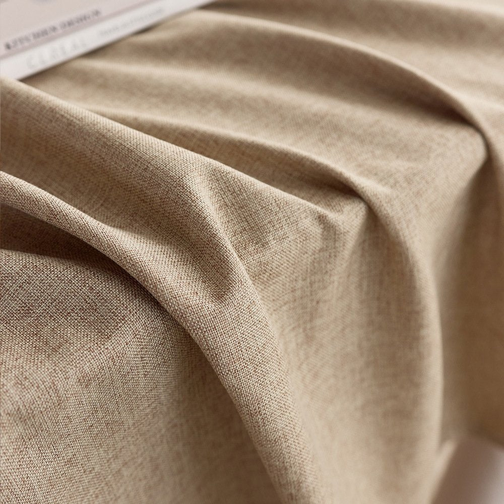 Sailorine close-up of beige tablecloth folds and woven texture