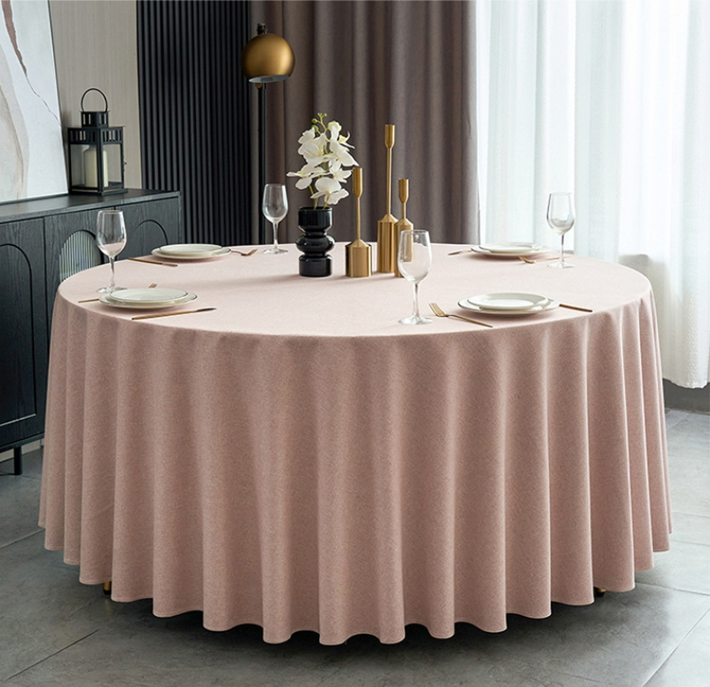 Sailorine blush round tablecloth with plates and a floral centerpiece