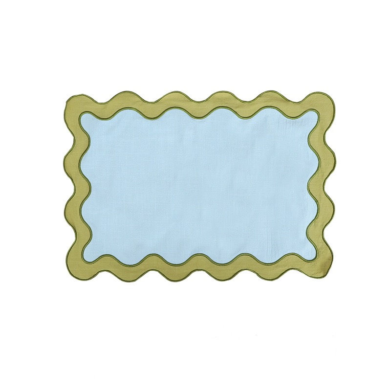 Sailorine pale blue placemat with a green scalloped border