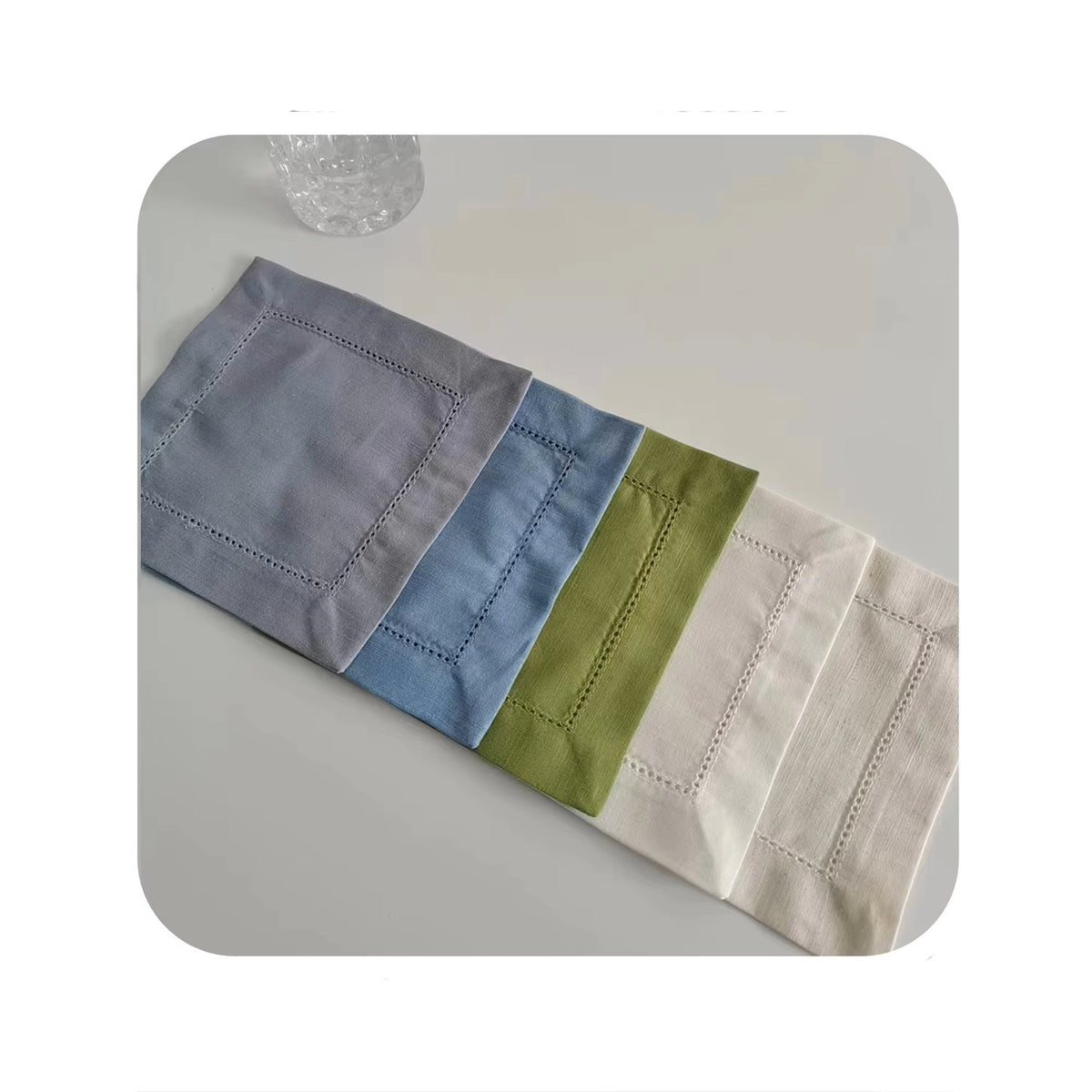 Sailorine gray, blue, green and white napkins arranged in a row