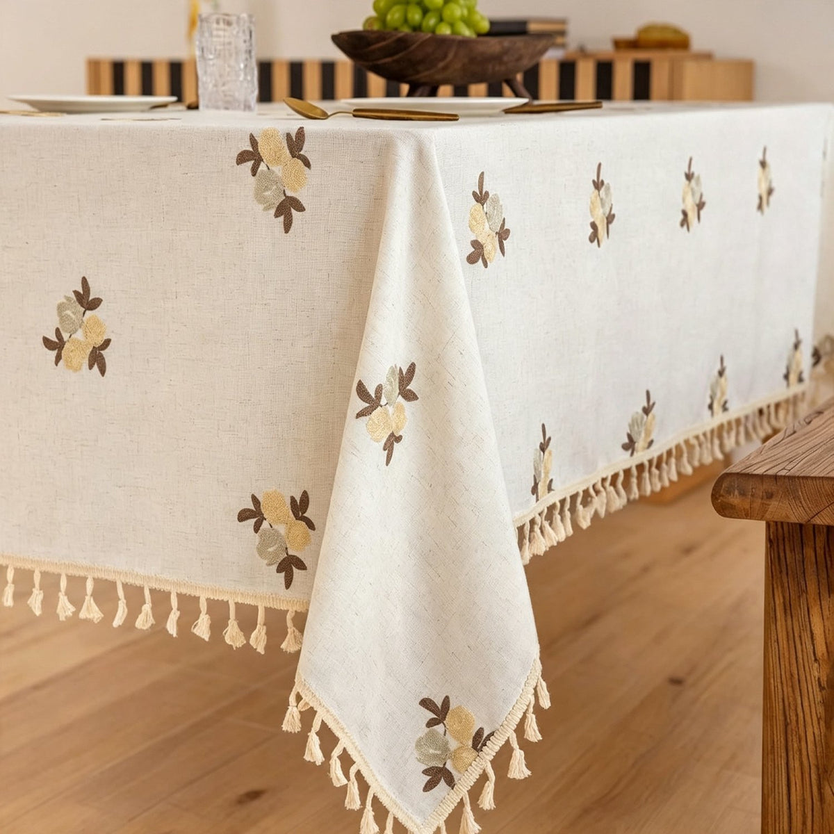 Sailorine floral tablecloth draped over a wooden dining table