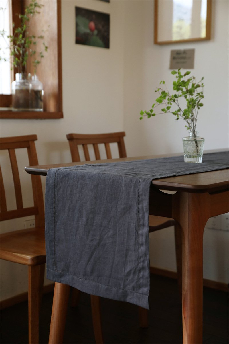 Sailorine dark gray table runner on a wooden dining table