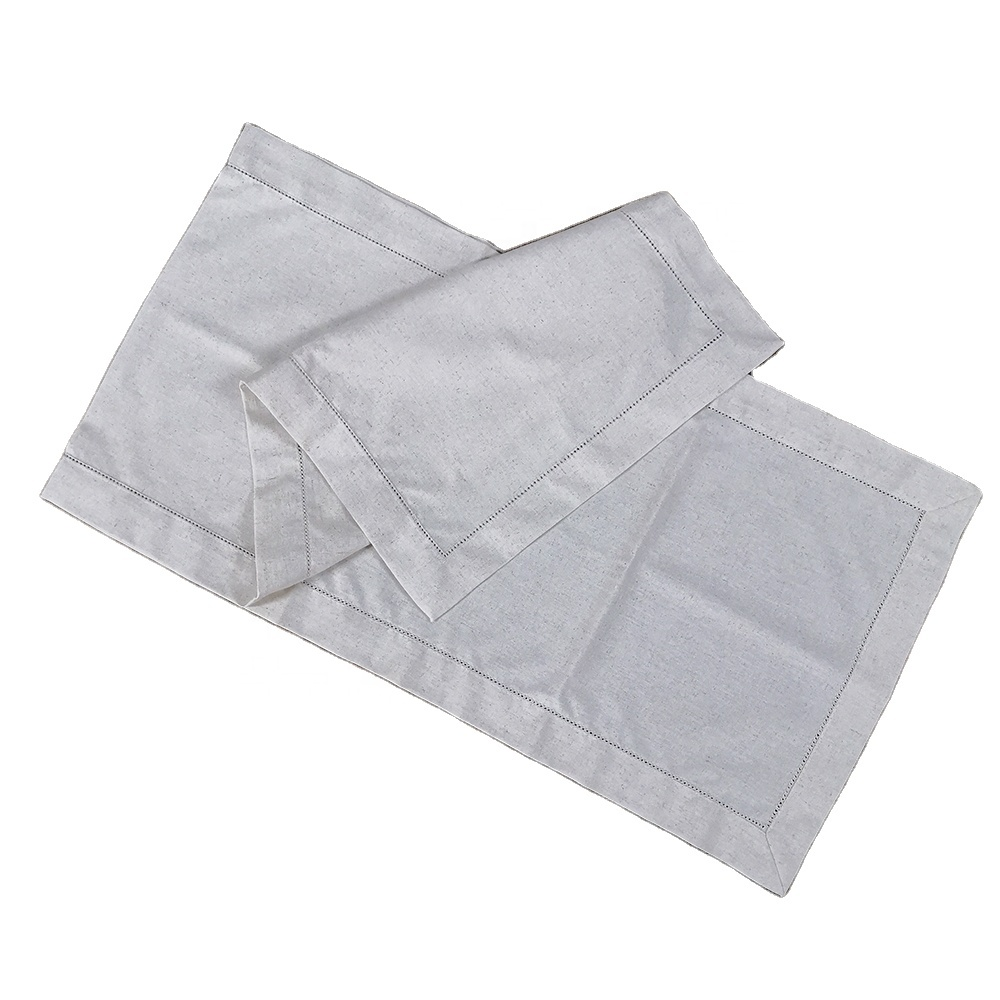 Sailorine pale table runner folded to show its rectangular stitched borders