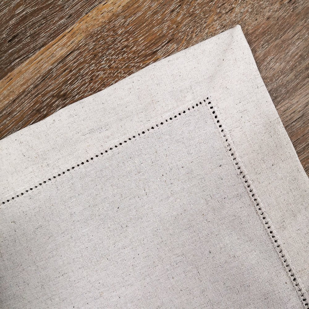 Sailorine close-up of openwork stitching at the corner of a pale table runner