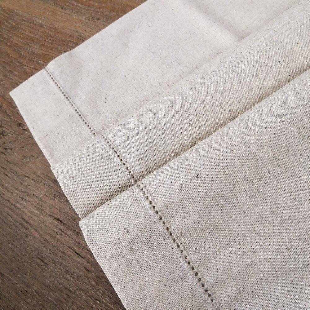 Sailorine pale table runner folded across its stitched border